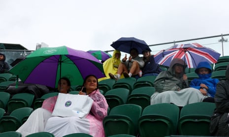 Umbrellas out on court.