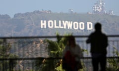 two people in the foreground of the hollywood sign