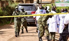 Security forces and forensic experts secure the scene of an attempted assassination on Ugandan minister of works and transport General Katumba Wamala
