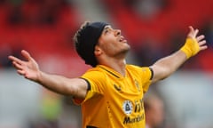 The Wolves striker Raúl Jiménez, wearing a headband after recovering from a fractured skull, celebrates after scoring against Stoke in pre-season