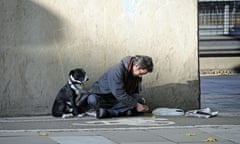 Homeless man with his dog in half shadow Euston Road London England UK. Image shot 10/2008. Exact date unknown.