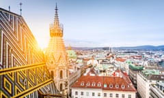 Aerial view over the historical rooftops of Vienna from the north tower of famous St. Stephen’s Cathedral in beautiful golden evening light at sunset<br>KW2CRY Aerial view over the historical rooftops of Vienna from the north tower of famous St. Stephen’s Cathedral in beautiful golden evening light at sunset