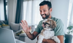 Man sitting with his pet dog and using laptop for video call at home