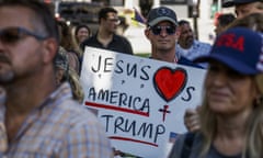 Trump supporters. One is carrying a placard that reads: 'Jesus loves Trump and America'; others are wearing baseball caps with 'USA' and similar logos