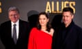 From left, Robert Zemeckis, Marion Cotillard and Brad Pitt at the Paris premiere of their film Allied.