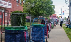 People facing with food insecurity wait in line for a meal served by Queens Together in New York outside a church