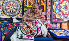 Salesman works on a carpet in the markets of al-Darb al-Ahmar.