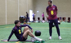 Gareth Southgate oversees Harry Maguire, who stretches on a mat.