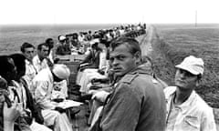 In this 1975 photo, prisoners ride a wagon train taking them to a work area at the Cummins Unit of Arkansas' Department of Corrections in Grady, Ark. The convict-leasing period, which officially ended in 1928, helped chart the path to America's modern-day prison-industrial complex. Incarceration was used not just for punishment or rehabilitation but for profit. (Bruce Jackson via AP)