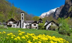 Old stone houses mountains, flowers and blue sky