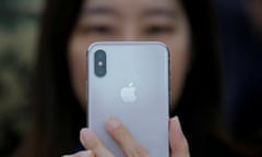FILE PHOTO: A attendee uses a new iPhone X during a presentation for the media in Beijing, China October 31, 2017. REUTERS/Thomas Peter/File Photo
