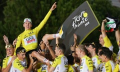 Tadej Pogacar is tossed up in the air by UAE Team Emirates teammates and staff after his Tour de France triumph
