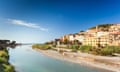 Colorful houses of Ventimiglia near river mouth Roya flowing into Mediterranean sea