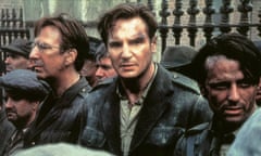 A battered-looking Liam Neeson, who starred as the eponymous Michael Collins, is flanked by actors Alan Rickman and Aidan Quinn in a scene from the film