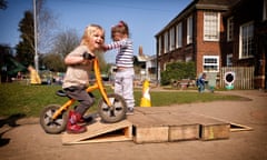 Two happy girls play on bikes