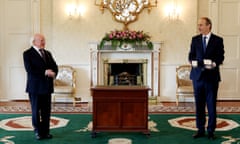 Micheál Martin, right, is presented with Ireland’s seal of office by President Michael D Higgins in Dublin.