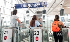 Passengers use the ePassport gates at UK border control, Stansted airport.