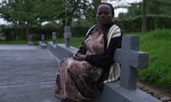 Marie Golithi Uwisenga, who lost 14 relatives in the Rwandan genocide, in the family cemetery where they are buried beside her home