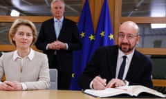 The president of the European council, Charles Michel (right), and the European commission president, Ursula von der Leyen, sign the withdrawal agreement, watched by the EU’s chief Brexit negotiator, Michel Barnier, in Brussels