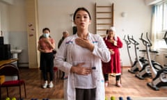 Nurse Aidai Temiraly kyzy does breathing exercises with female COPD patients.