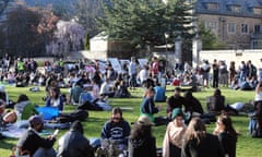 students sit on grass