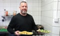 Jim Anderson holding plates of vegan food