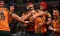 Filipo Daugunu is mobbed after scoring one of his two tries in the Wallabies’ win over Wales at Melbourne’s AAMI Park.