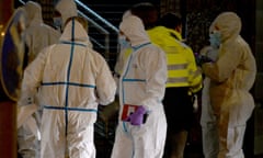 Forensic experts wait to enter the building after the shooting at a Jehovah's Witnesses hall in Hamburg, Germany.