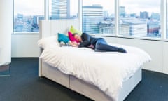 Man napping on a bed in the office