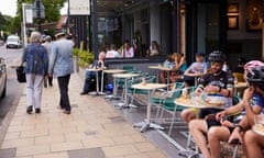 People sit at cafes in Didsbury, a south Manchester suburb.