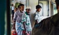 Men of various ages disembark a train