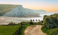 A country track leading down to the majestic Seven Sisters cliffs beyond at Cuckmere Haven in the south of England, UK.