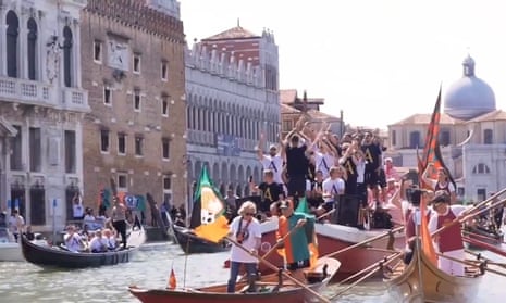 Venezia players celebrate return to Serie A with boat parade through city – video