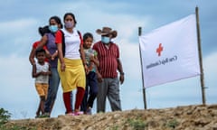 Venezuelan refugees walk to receive assistance from the Colombian Red Cross, in Arauquita, Colombia, March 2021