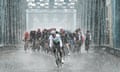 The Tour de Yorkshire peloton, led by Nicholas Dlamini of Dimension Data, crosses Boothferry Bridge on their way to Howden amid a torrential downpour