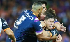 Malakai Watene-Zelezniak of Wests Tigers gets tackled against Melbourne Storm.