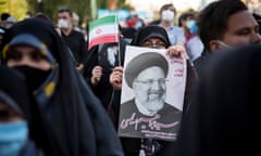 Supporters hold a poster of the hardline candidate Ebrahim Raisi in Tehran on 11 June.