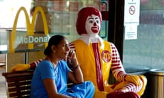 Indian woman sitting on bench at McDonald's fast food restaurant, Varanasi, Uttar Pradesh, India, Asia<br>C3TKG0 Indian woman sitting on bench at McDonald's fast food restaurant, Varanasi, Uttar Pradesh, India, Asia