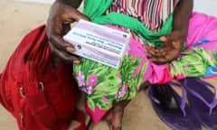 An Indigenous woman holding medication