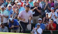 The crowd applaud Francesco Molinari after his bunker shot on the 18th left him with a near tap-in to take a two-shot lead into the final day at the Masters