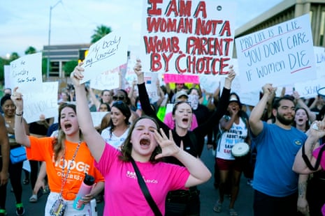 Protesters join thousands marching around the Arizona capitol in Phoenix, protesting the US supreme court's decision to overturn Roe v Wade, 24 June 2022.