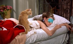 Holly Golightly, played by Audrey Hepburn, sleeping with her cat in Breakfast at Tiffany’s.