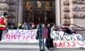 Greta Thunberg (fourth left) and other activists hold a banner reading 'Climate Justice Now' as they sit on steps outside the parliament entrance