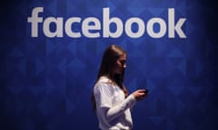 Facebook jobs<br>File photo dated 03/11/15 of a woman using her phone under a Facebook logo, as the company is looking for a head of news amid concerns over so-called fake news and how the social network deals with it. PRESS ASSOCIATION Photo. Issue date: Tuesday December 13, 2016. A job advert looking for a head of news partnerships has been posted to the social media giant’s careers site, which says it is looking for applicants with “20+ years experience in news”, a requirement that means those applying must have started their career when Facebook founder Mark Zuckerberg was 13. See PA story TECHNOLOGY Facebook. Photo credit should read: Niall Carson/PA Wire