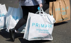 Shoppers carry Primark bags