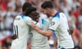 Bukayo Saka of England celebrates his second goal with Marcus Rashford and Declan Rice.