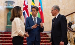 Ana Toni, Ed Miliband and Mukhtar Babayev speaking on a grand staircase against their national flags