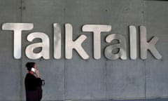 A woman speaks on her phone as she passes a branded logo outside the TalkTalk headquarters in London