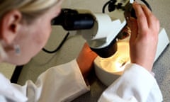 Woman looking through microscope