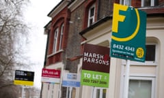 a row of to let signs outside houses